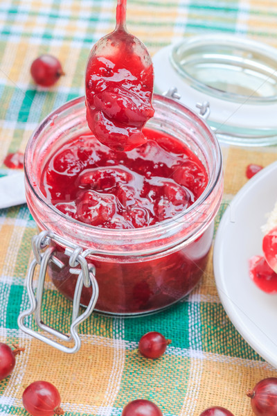 Scooping gooseberry jam jar spoon Stock photo © fotoaloja