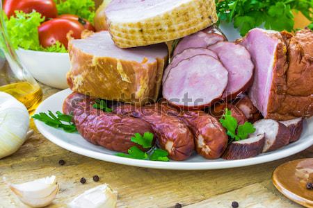 plate various kinds sausages surrounded greens Stock photo © fotoaloja