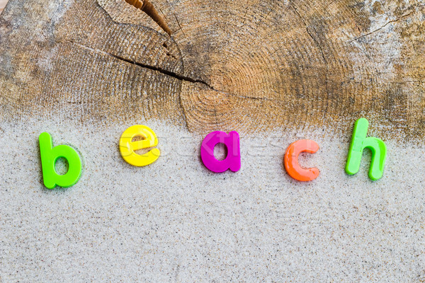 Stock photo: The word beach laid sand