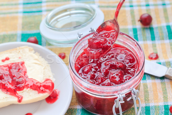 Scooping gooseberry jam jar spoon Stock photo © fotoaloja