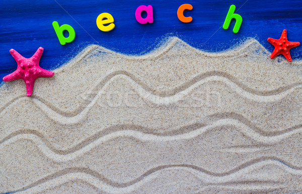 Stock photo: The word beach laid sand