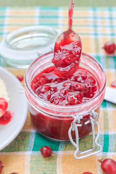 Stock photo: Scooping gooseberry jam jar spoon