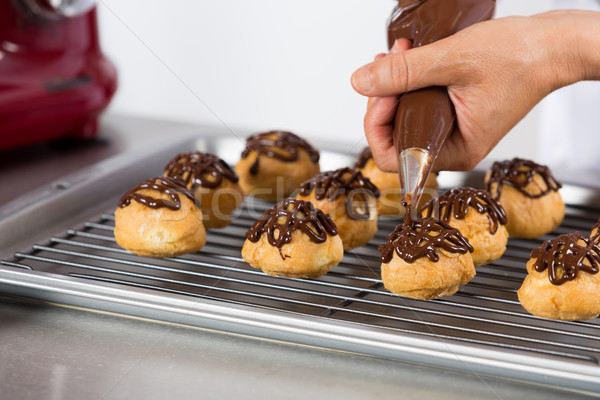 Chef decorating some profiteroles Stock photo © fotoedu