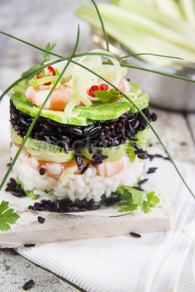 Stock photo: Tower of black and white rice with shrimp and zucchini