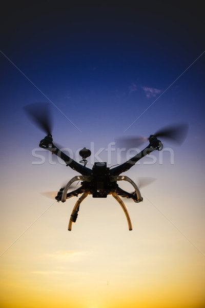 Quadrocopter in flight at sunset Stock photo © Fotografiche