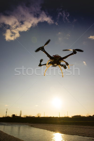 Quadrocopter in flight at sunset Stock photo © Fotografiche