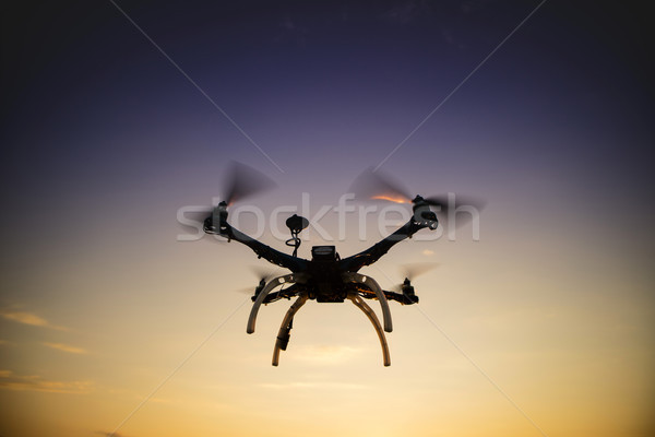 Quadrocopter in flight at sunset Stock photo © Fotografiche
