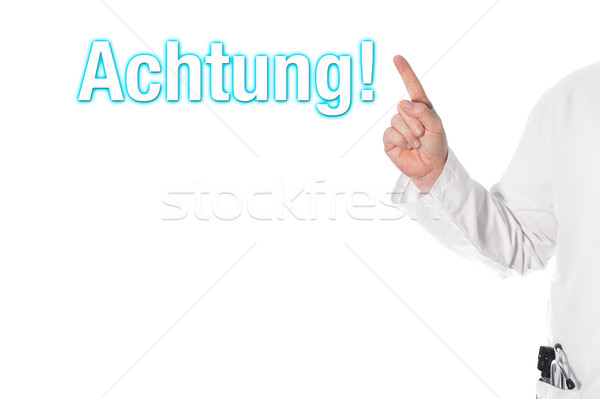 Doctor pointing at a title (attention) Stock photo © fotoquique