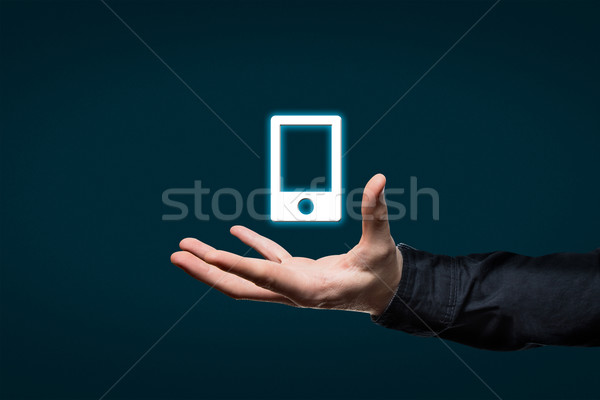 businessman holds a virtual pictogram Stock photo © fotoquique