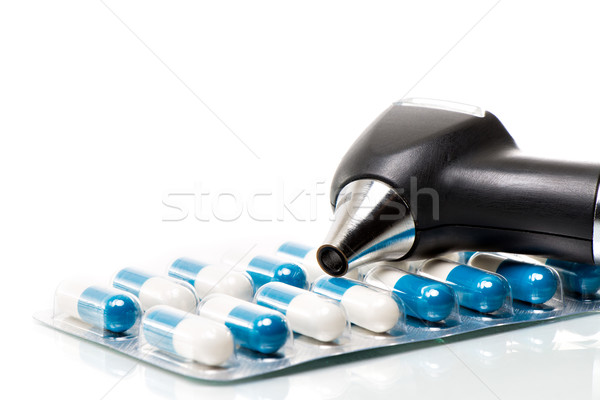 Otoscope on a blister of tablets Stock photo © fotoquique