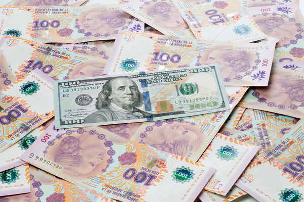 US dollar and Argentine peso bills Stock photo © fotoquique