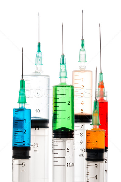 Various syringes filled with colored liquids Stock photo © fotoquique