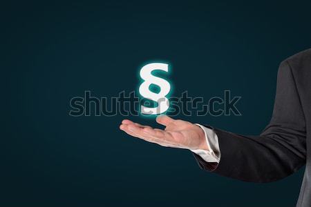 Businessman holding a virtual paragraph icon Stock photo © fotoquique