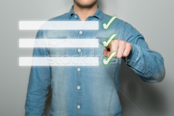 Man pointing virtual checklist Stock photo © fotoquique