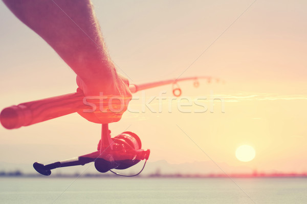 Pescuit mână frumos cer apă soare Imagine de stoc © FotoVika