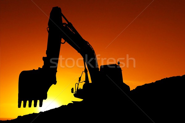 Stock photo: Silhouetted Digging Machine