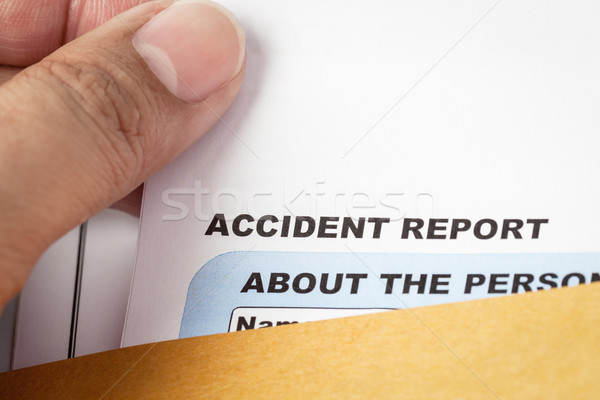 Accident report application form and pen on brown envelope and e Stock photo © FrameAngel