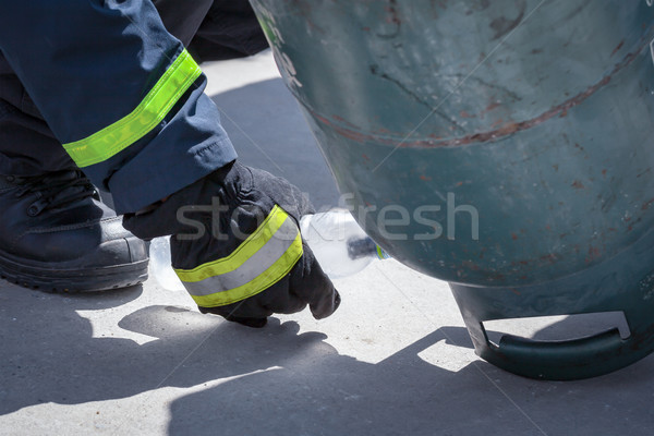 fire trainer, pouring liquid LPG gas into bottle by upside down  Stock photo © FrameAngel