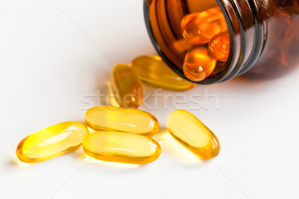 Yellow pills and bottle on white background close up Stock photo © FrameAngel