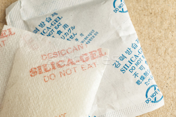 Close up silica gel or desiccant, non-english text translate to 'Silica Gel Do not Eat' in paper bag Stock photo © FrameAngel