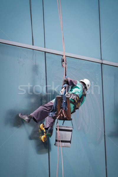 worker cleaning windows service on high rise building Stock photo © FrameAngel