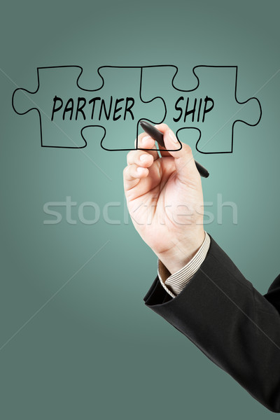 Businessman drawing partnership puzzle pieces Stock photo © FrameAngel