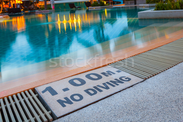 warning sign '1.00m No Diving' at Swimming pool of luxury hotel Stock photo © FrameAngel