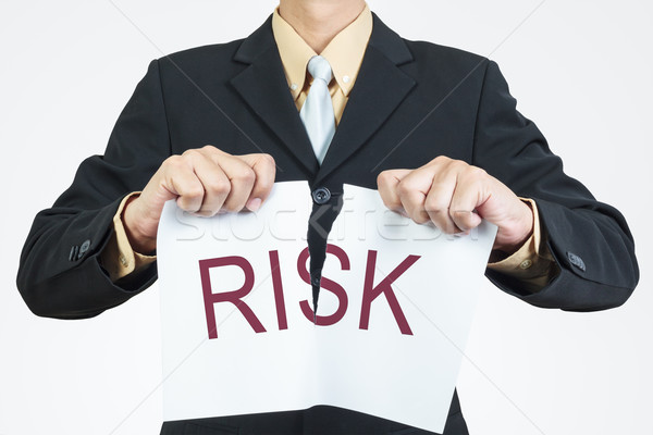 Businessman tearing sheet paper, risk management concept Stock photo © FrameAngel