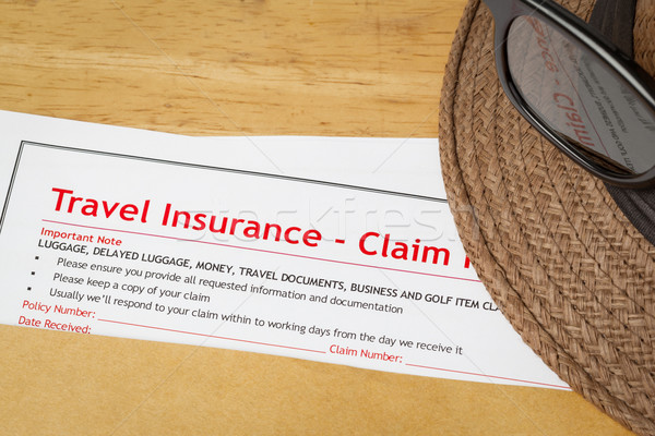 Travel Insurance Claim application form and hat with eyeglass on Stock photo © FrameAngel