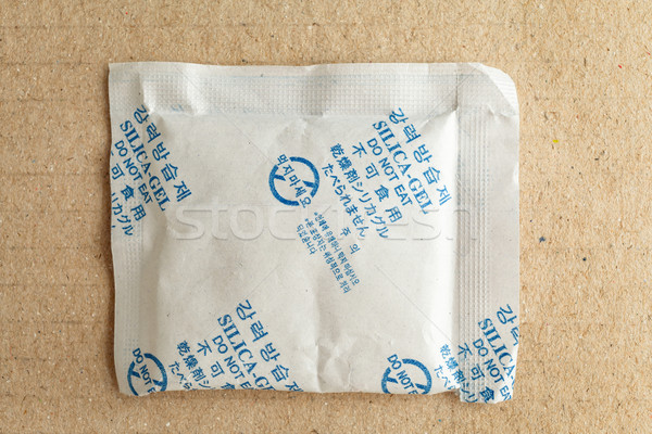 Close up silica gel or desiccant, non-english text translate to 'Silica Gel Do not Eat' in paper bag Stock photo © FrameAngel