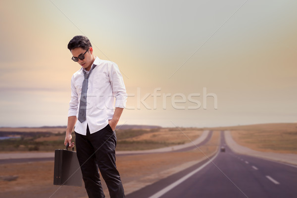 Asian Businessman tired and standing on road at upcountry out of Stock photo © FrameAngel