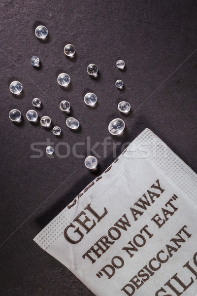 Close up silica gel or desiccant in paper bag on black backgroun Stock photo © FrameAngel