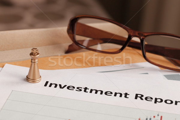 Investment Report letter document and eyeglass; document is mock Stock photo © FrameAngel