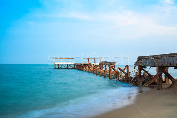 Eski zarar kum plaj su gün batımı Stok fotoğraf © FrameAngel
