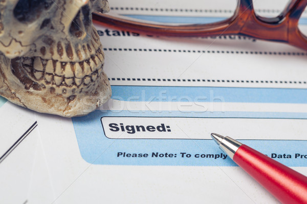 Signature field on document with pen and skull signed here; docu Stock photo © FrameAngel
