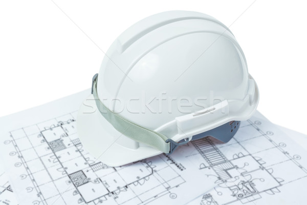 engineering concept, safety helmet with working plan Stock photo © FrameAngel