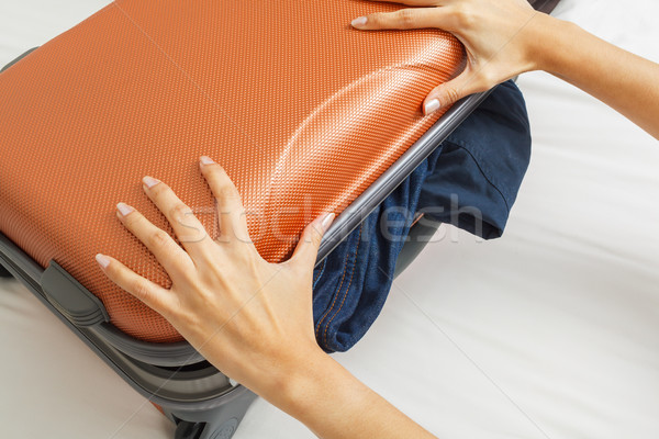 open suitcase with clothes on bed Stock photo © FrameAngel