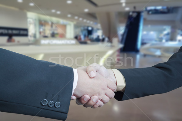 Business handshake with blur background of shopping mall market Stock photo © FrameAngel