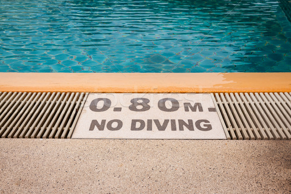 warning sign '0.80m No Diving' at Swimming pool of luxury hotel Stock photo © FrameAngel