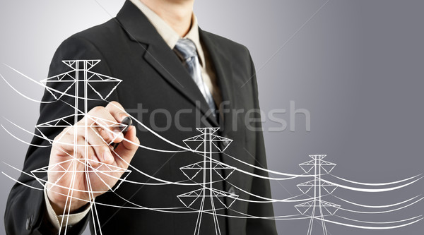 business man drawing electric pylon and wire Stock photo © FrameAngel