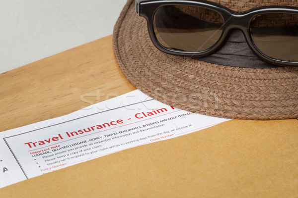 Travel Insurance Claim application form and hat with eyeglass on Stock photo © FrameAngel