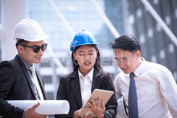 Stock photo: Asian businessman and woman discuss with engineer architect prof