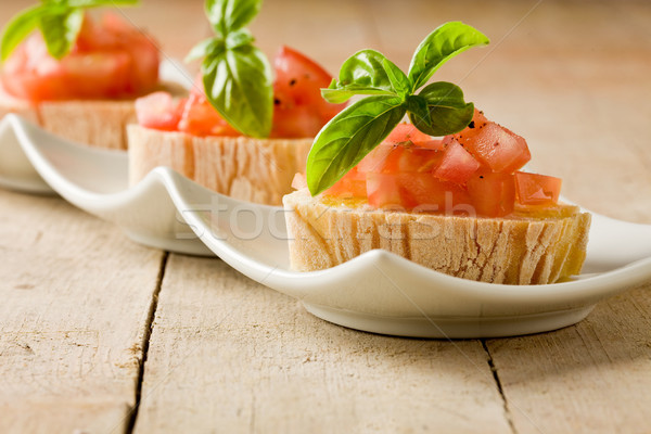 Bruschetta paradicsomok bazsalikom fotó finom fa asztal Stock fotó © Francesco83