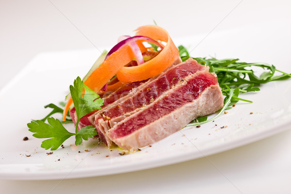 Stock photo: Chopped Tuna over fresh arugula salad