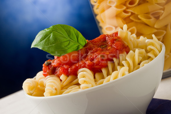 Pasta with tomato sauce and basil on blue background Stock photo © Francesco83