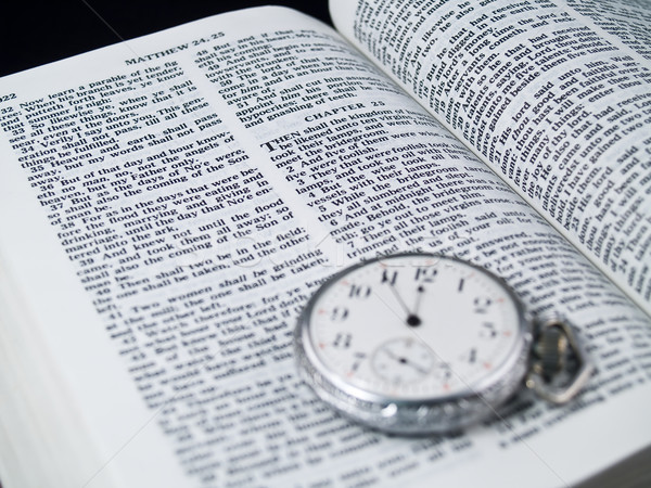 Stock photo: The Bible opened to Matthew 24: 36 with a Pocketwatch