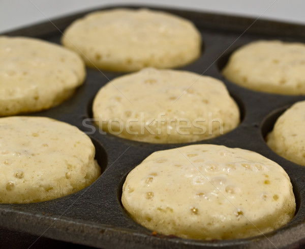 A Batch of Aebelskivers Cooking in a Pan Stock photo © Frankljr