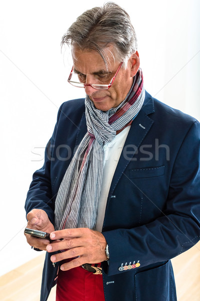 Stylish pensioner checking his mobile phone Stock photo © franky242