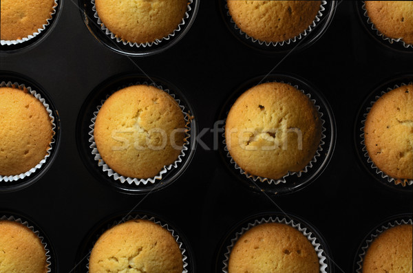 Freshly Baked Cupcakes in Tin with Splatters Overhead View Stock photo © frannyanne