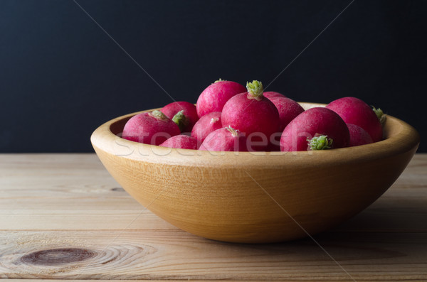 Wooden Bowl of Radishes on Black Background Stock photo © frannyanne